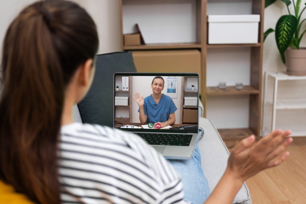 Smiling doctor greeting patient via video call, telehealth services